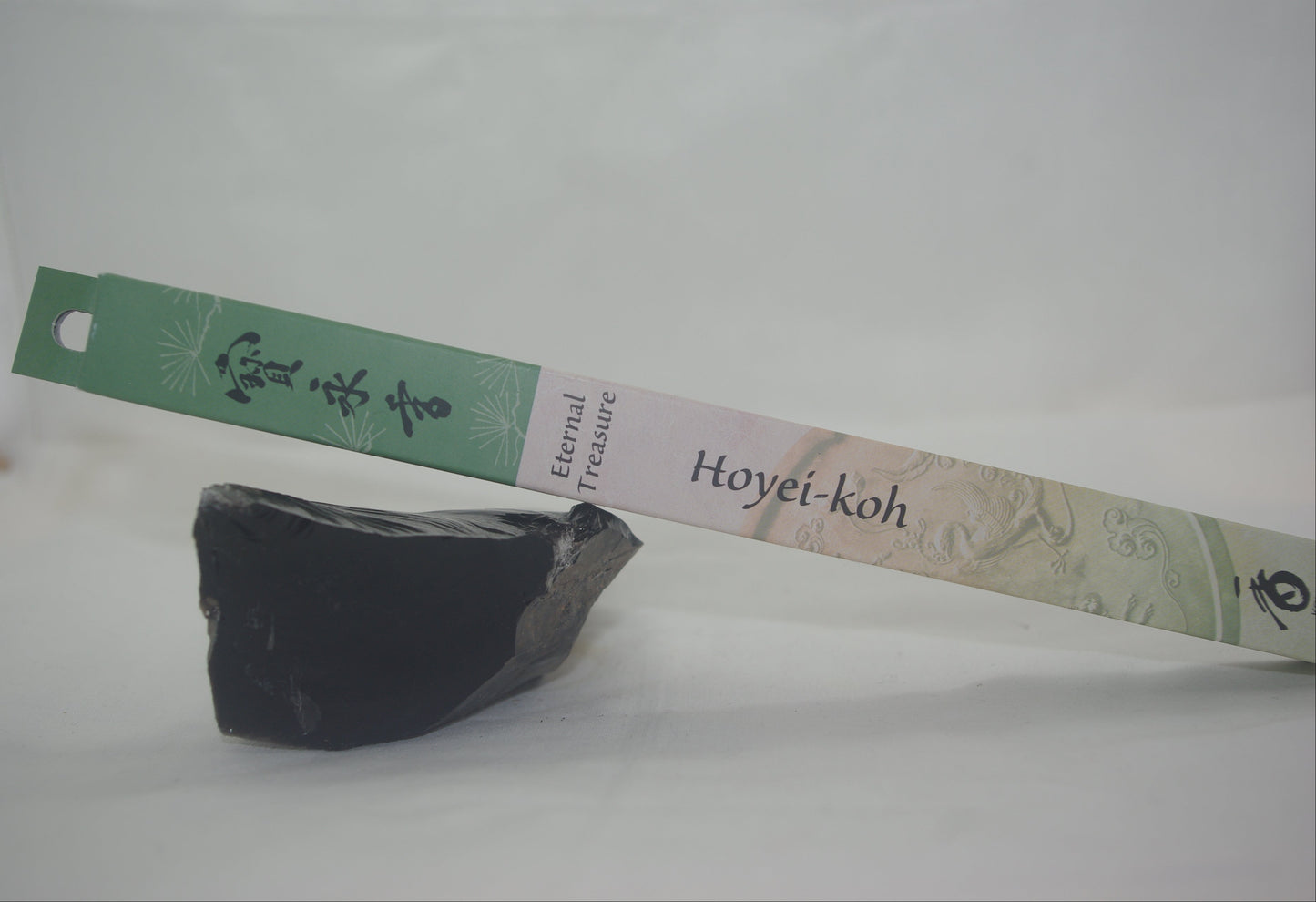 Black stone with a Hoyei-koh label on a white background