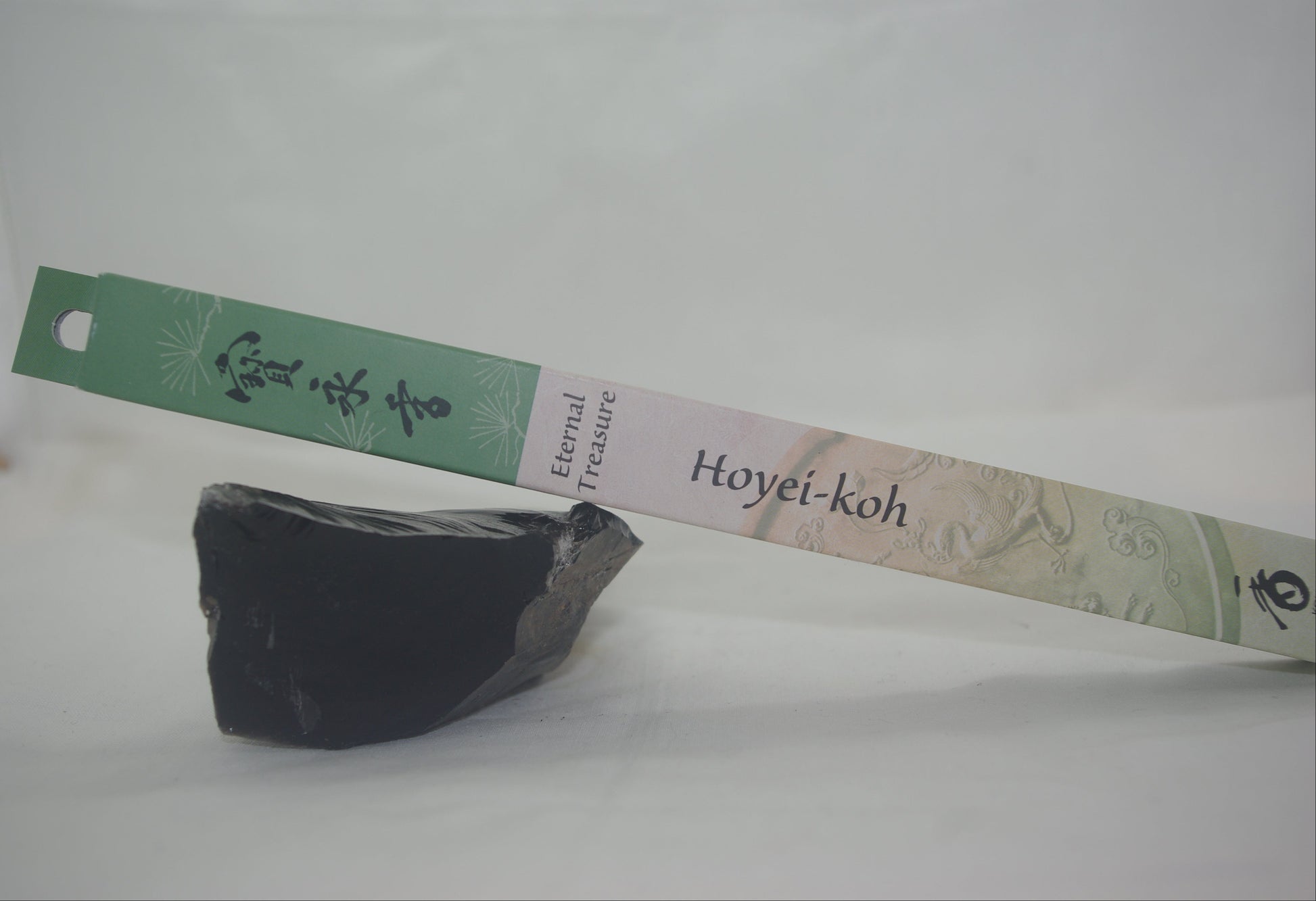 Black stone with a Hoyei-koh label on a white background