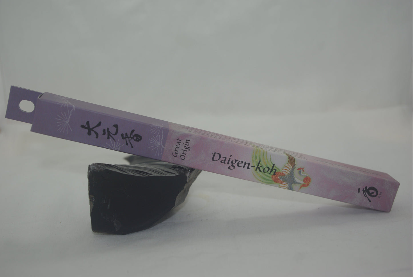 Incense stick with a purple label on a white background