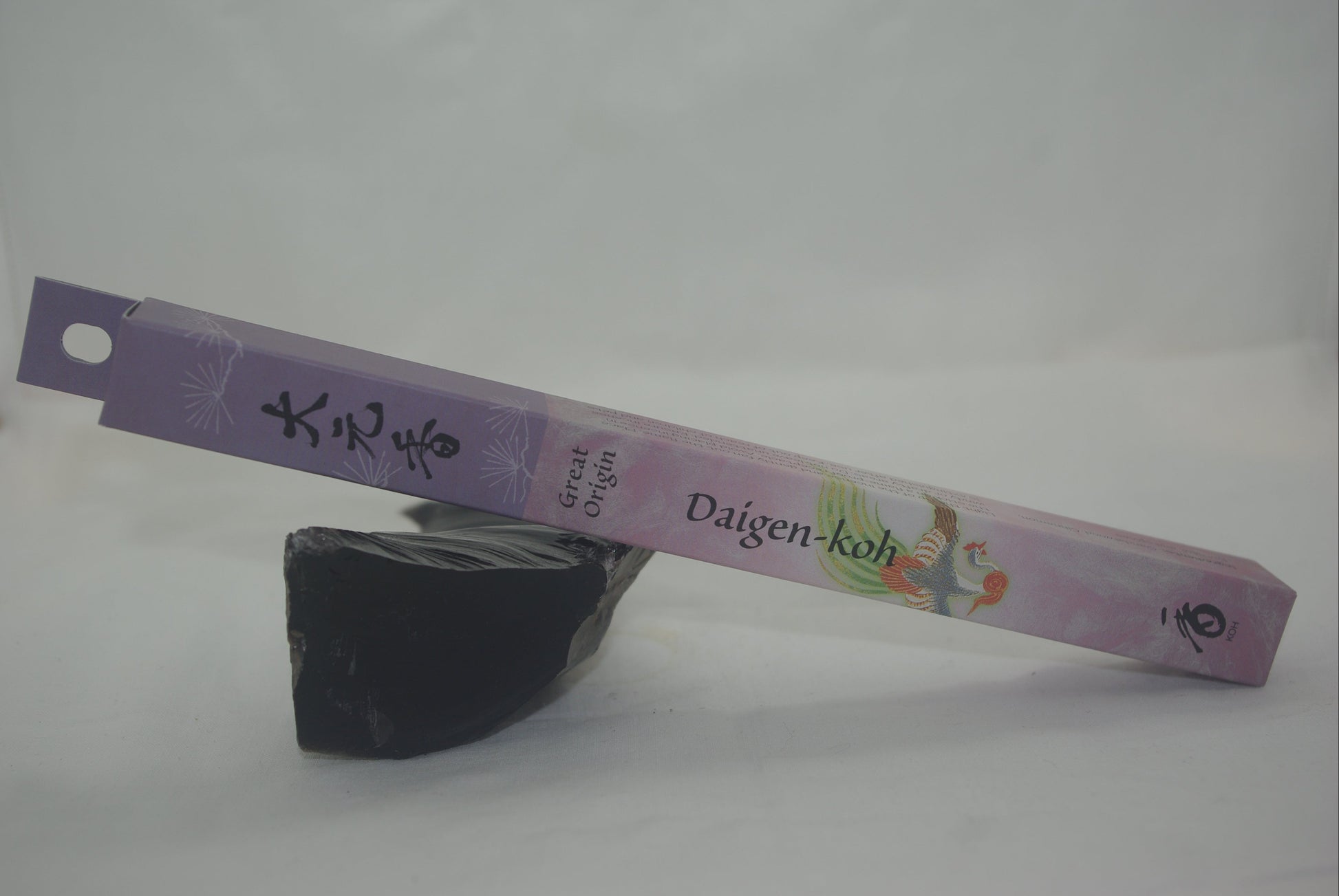Incense stick with a purple label on a white background